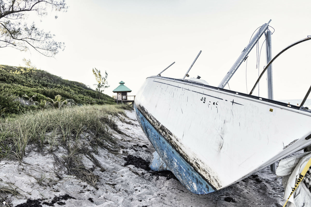 Boat Wreck on Beach with Lifeguard Tower in Background