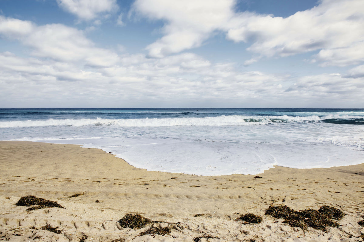 Florida, Delray, Gentle Waves Rolling Onto a Sandy Shore Under a Bright Sky Along the Atlantic Ocean
