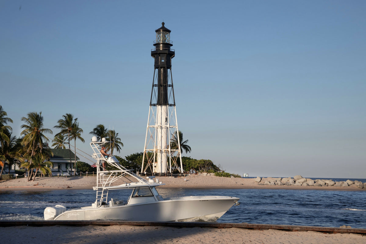 Florida, South Florida, Pompano Beach, View of Hillsboro Lighthouse and Fishing Boat