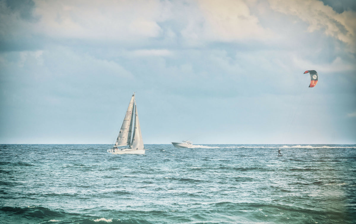 Sailboat, Yacht, and Kitesurfer Having Fun on the Ocean