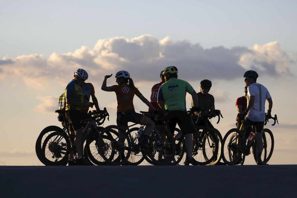 Dramatic Group of Cyclists Silhouetted at Sunset