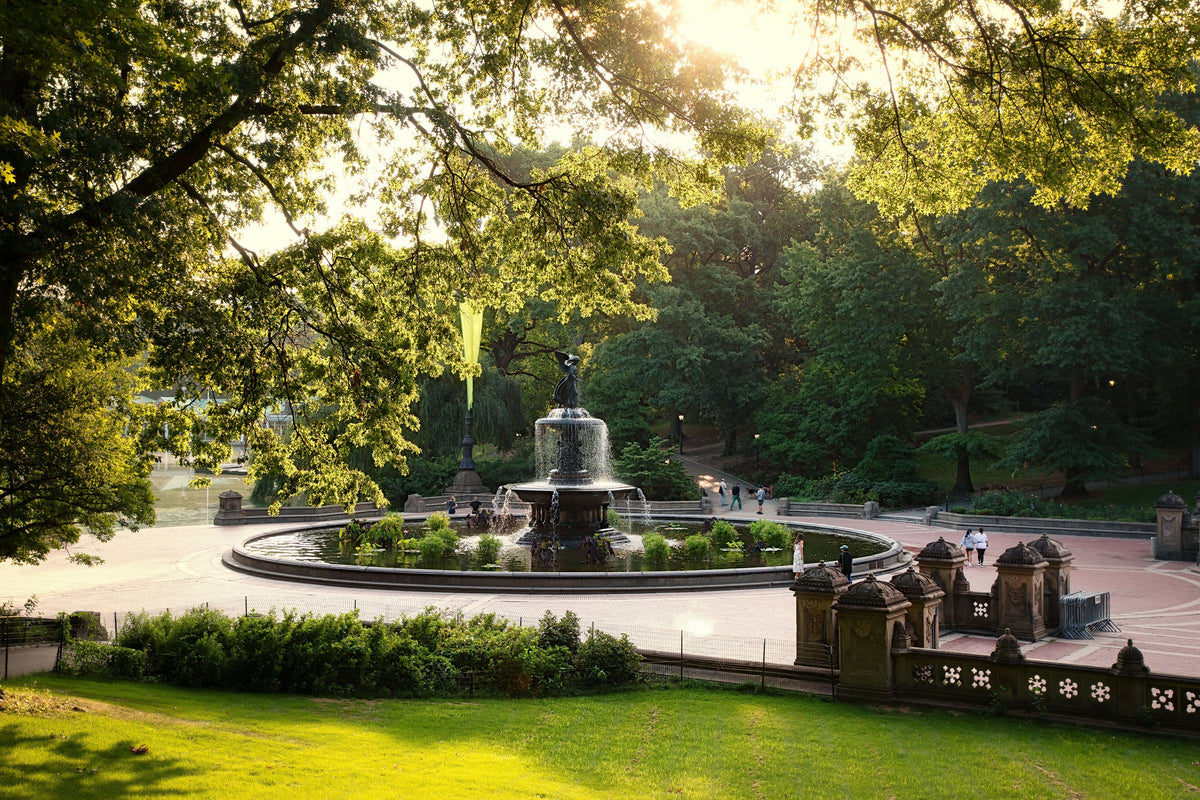 USA, New York City, Manhattan, Central Park, Bethesda Fountain and Terrace in Warm Evening Light, Surrounded by Lush Summer Greenery and Mature Trees