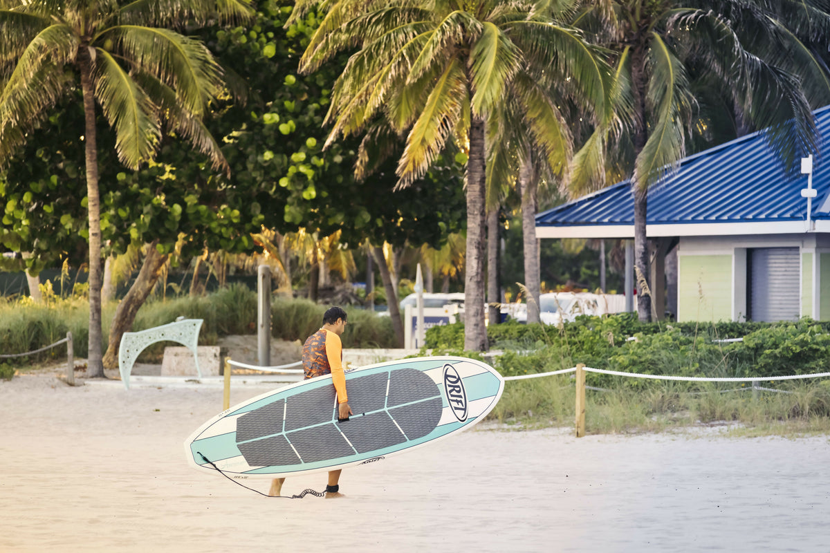 Florida, South Florida, Pompano Beach, Man Walking with Surfboard